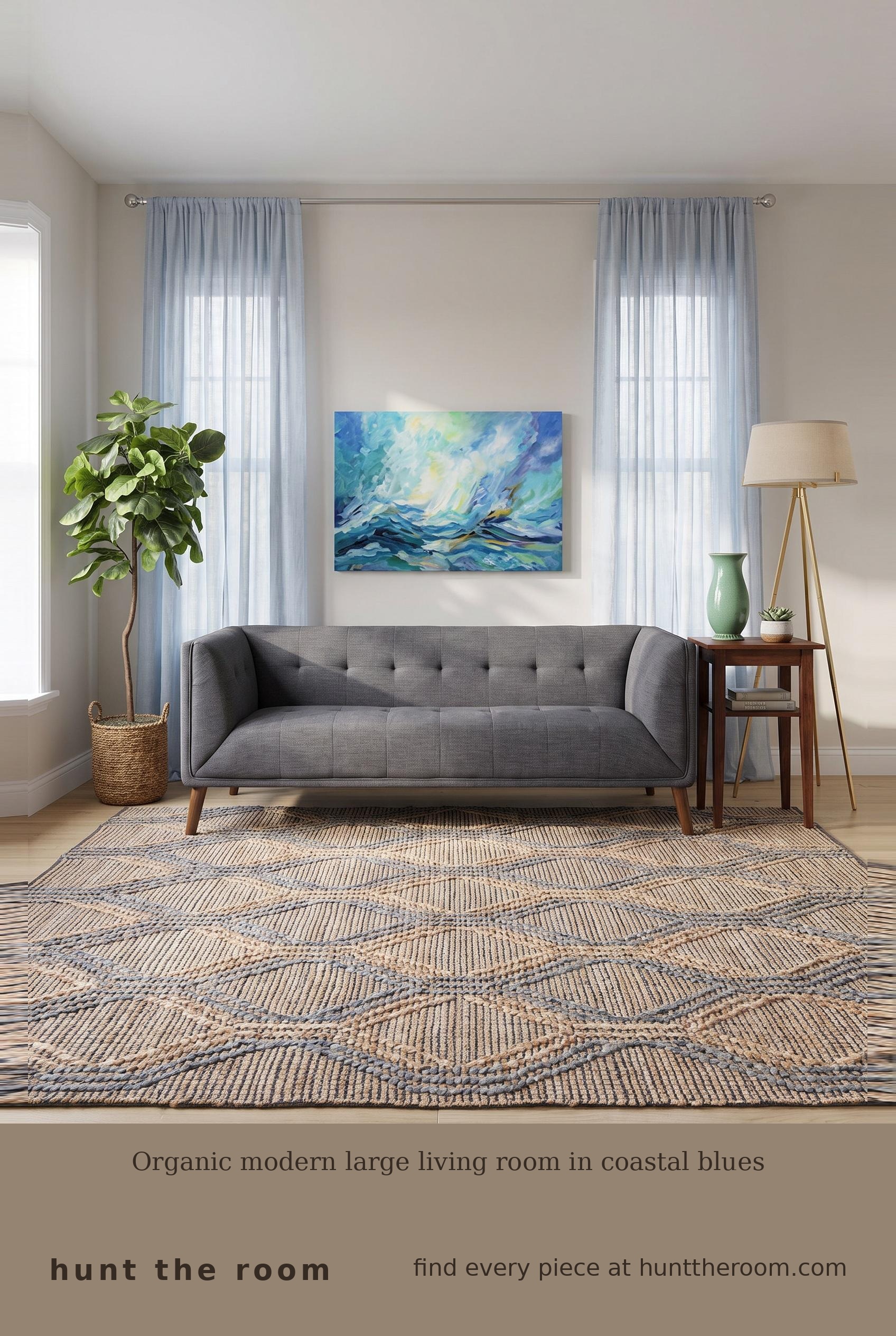 Flat lay of an organic modern coastal living room edit featuring a dark gray linen sofa, walnut side table, tripod floor lamp with linen shade, blue and cream woven rug, sheer light blue linen curtain, abstract ocean canvas, green ceramic vase and artificial fiddle leaf fig plant in woven basket.